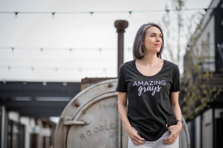 this organic girl wearing a black tshirt that says "amazing grays"