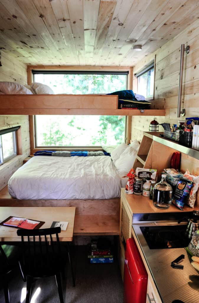 inside the Walter cabin at Getaway Atlanta with bunk queens a table and kitchen