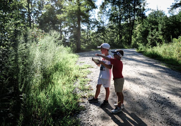 two boys pointing at a map exploring around the grounds of Getaway