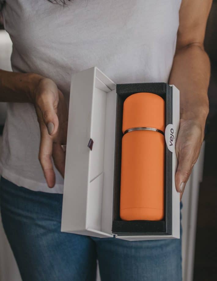 orange Vejo portable smoothie blender in its packaging