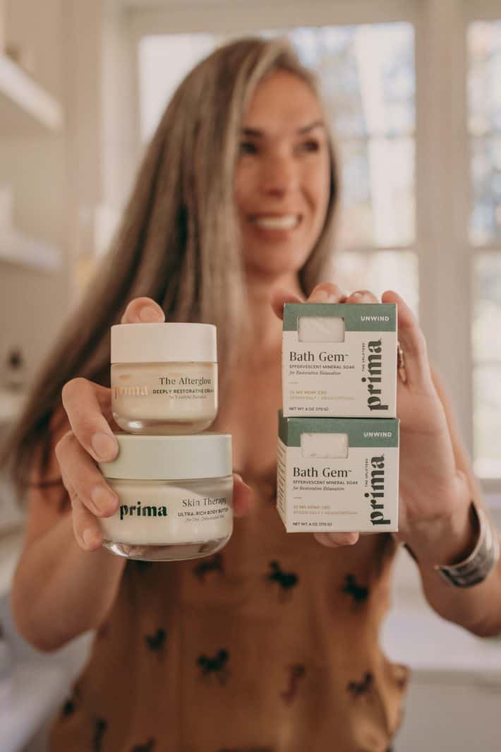 woman holding skincare products from Prima