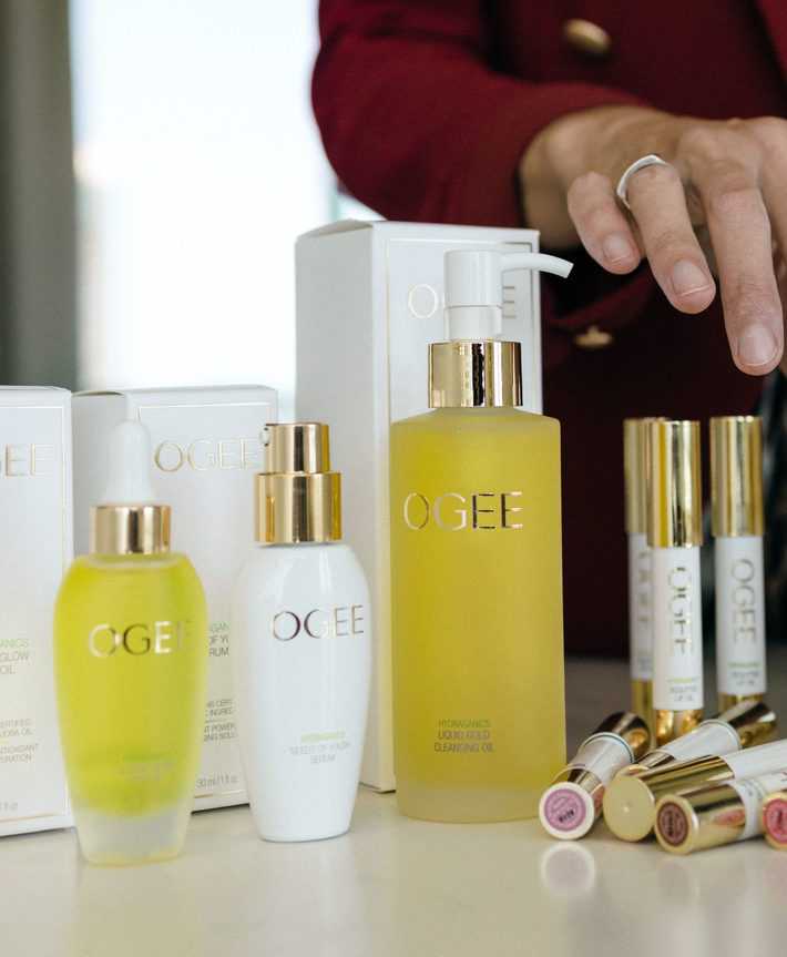 woman using OGEE skincare products