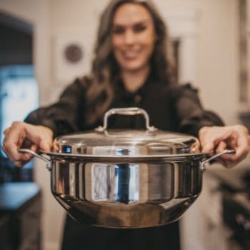 woman holding pot in hands from 360 cookware