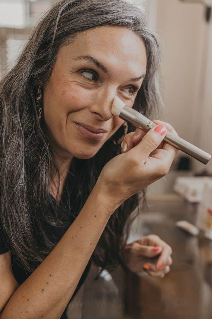 woman applying ILIA makeup 