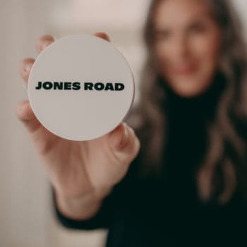 woman holding jones road product in her hand