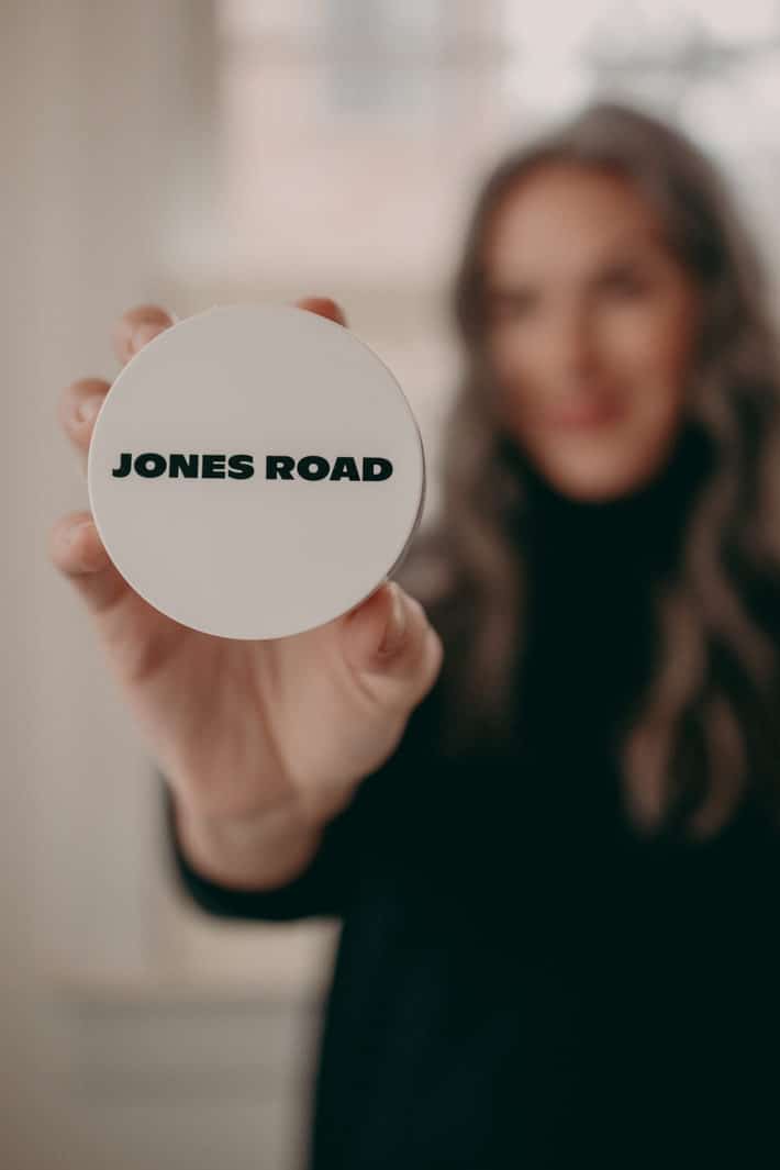 woman holding jones road beauty product in her hand