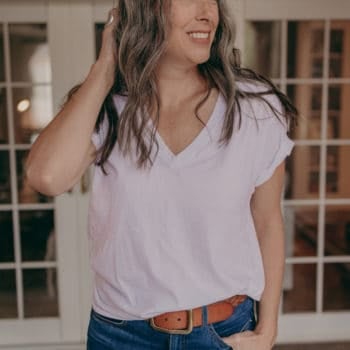 woman smiling in a white t shirt and jeans