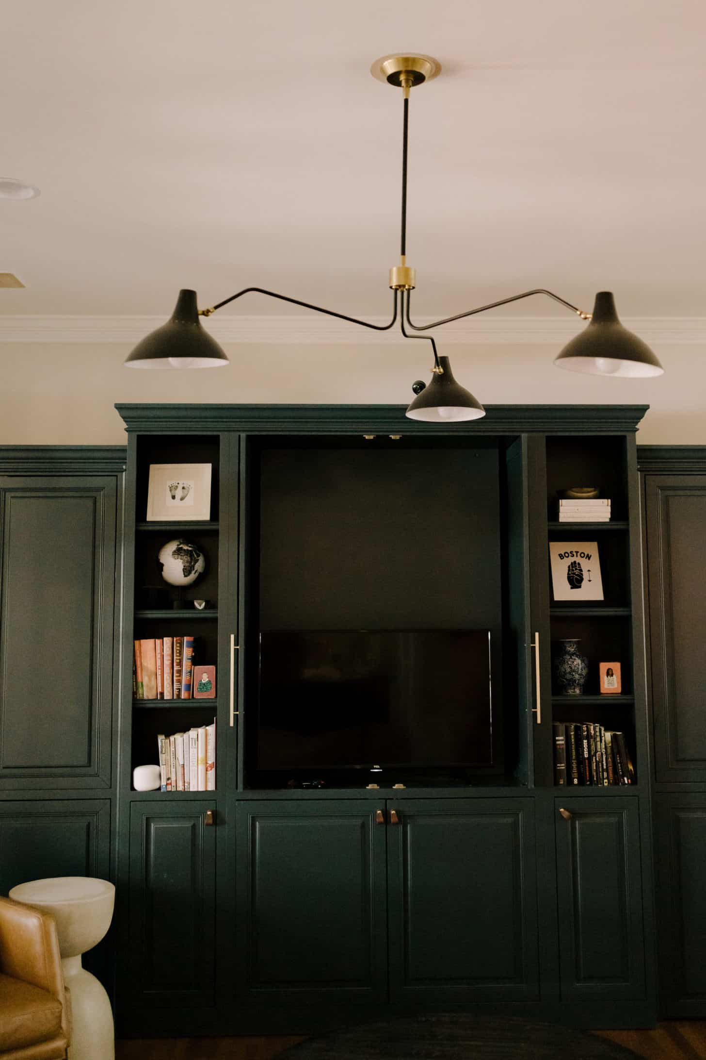 dark green built in book cases styled with accessories