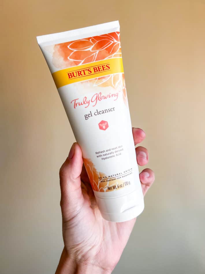hand holding bottle of burt's bees truly glowing gel cleanser