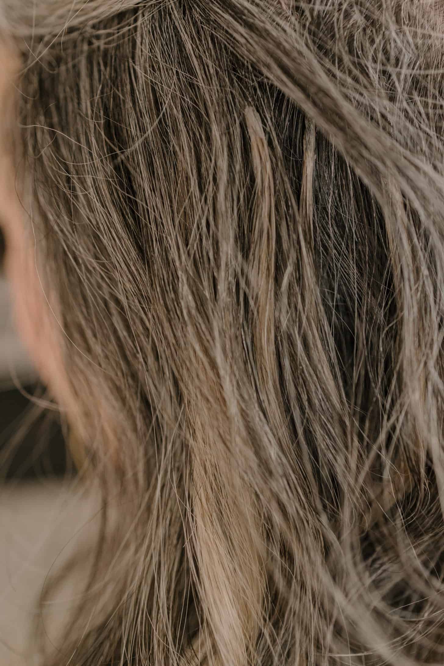a close up of long gray hair extensions on a woman