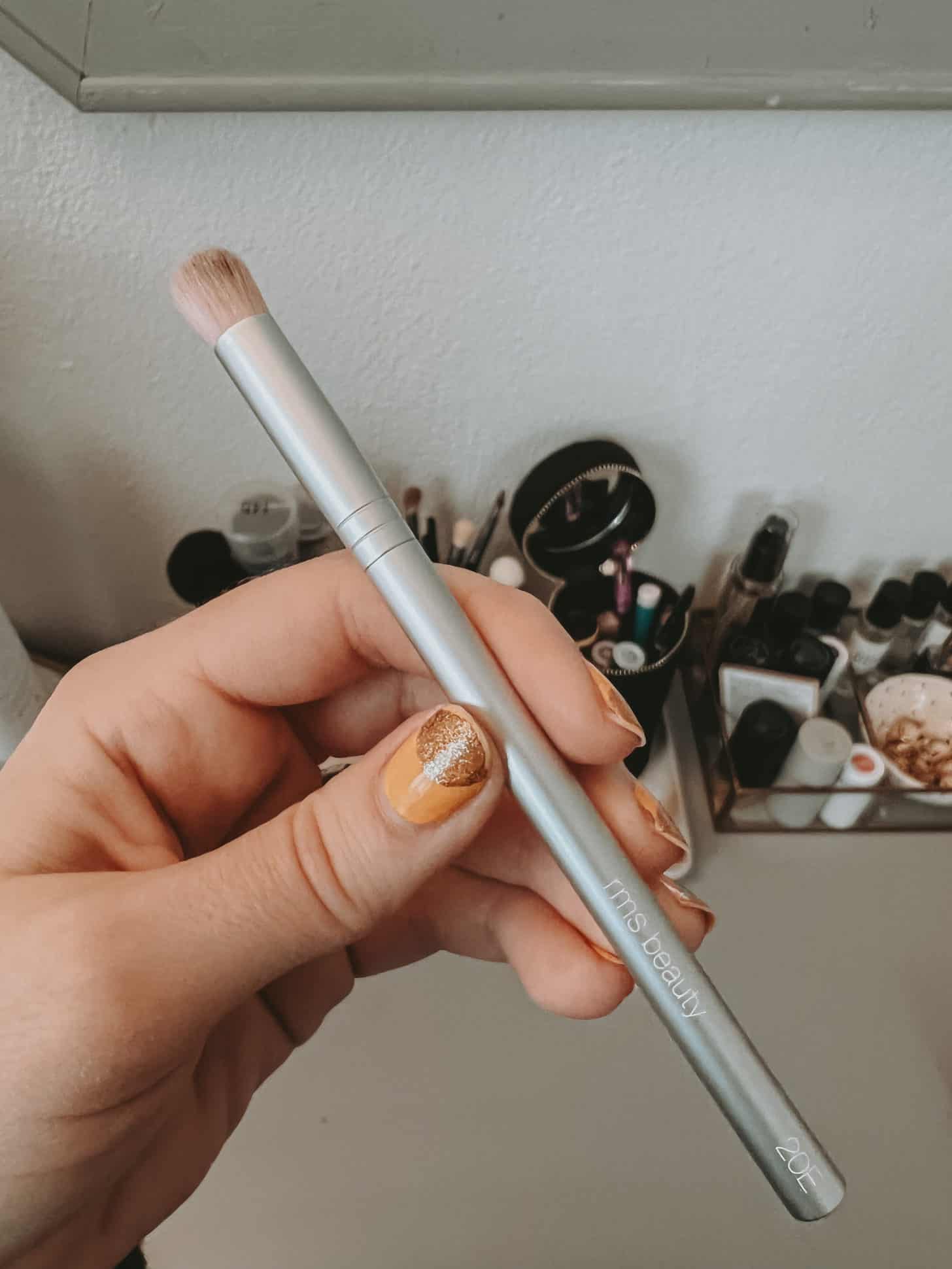 a close up of an rms  beauty cream eyeshadow brush
