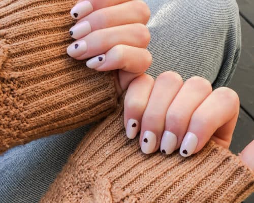 a close up of hands with olive and june press on nails