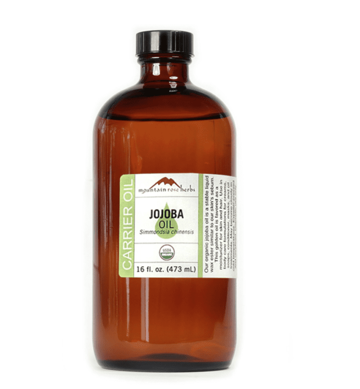 a brown bottle of organic jojoba oil