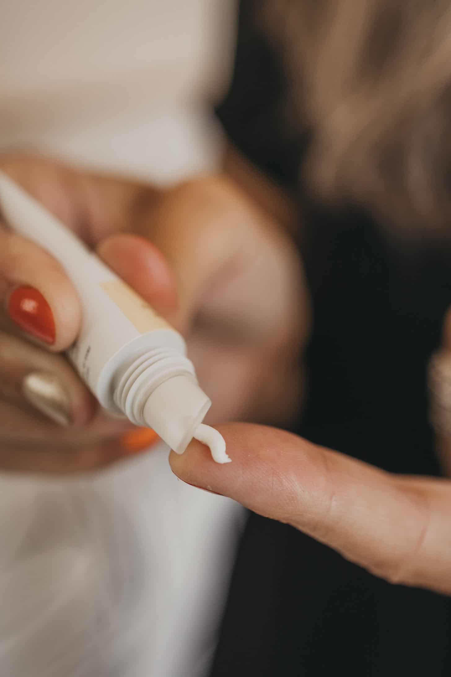 a close up of lip spf 15 being squeezed onto a finger