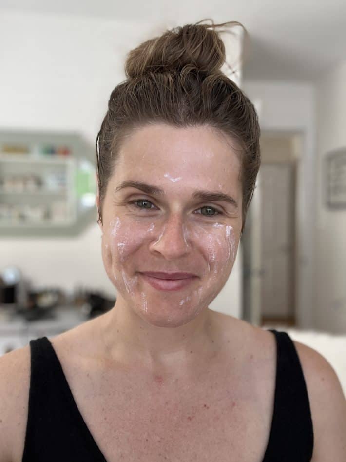 a woman's face mid-application of native face spf 30