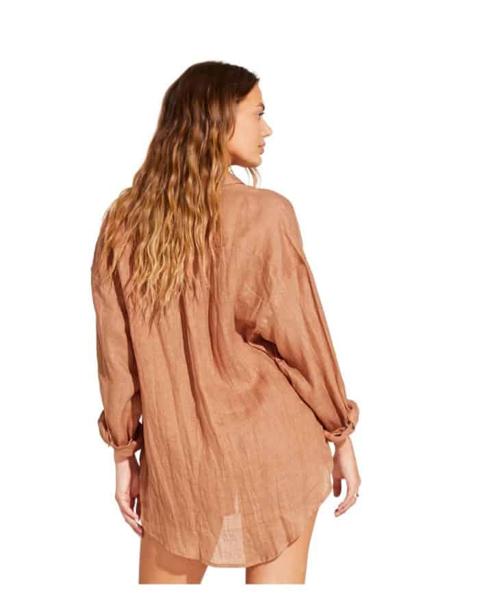 the back of a woman wearing a linen swimsuit cover up