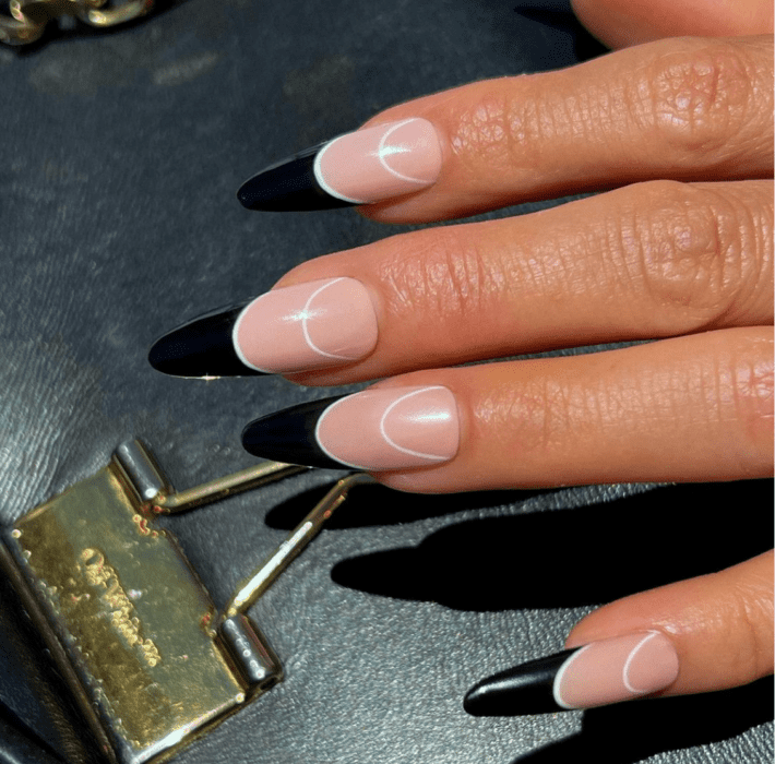 a close up of nails painted with black tips